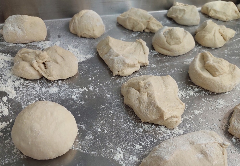 pizza dough being balled