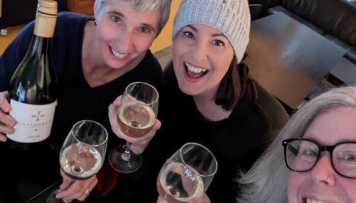 Three women celbrating with wine