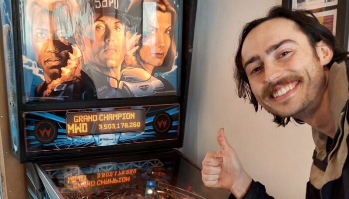 Pinball player enters their initials "MWO" as the new grand champion